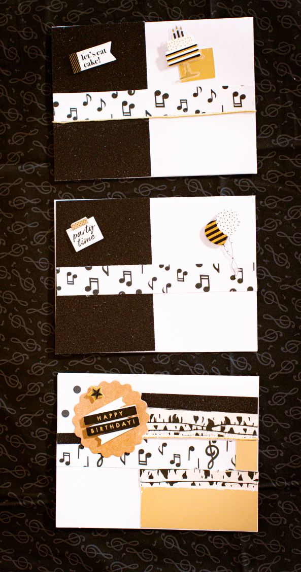 Set of greeting cards on sparkling black paper with musical notes and decorative elements.